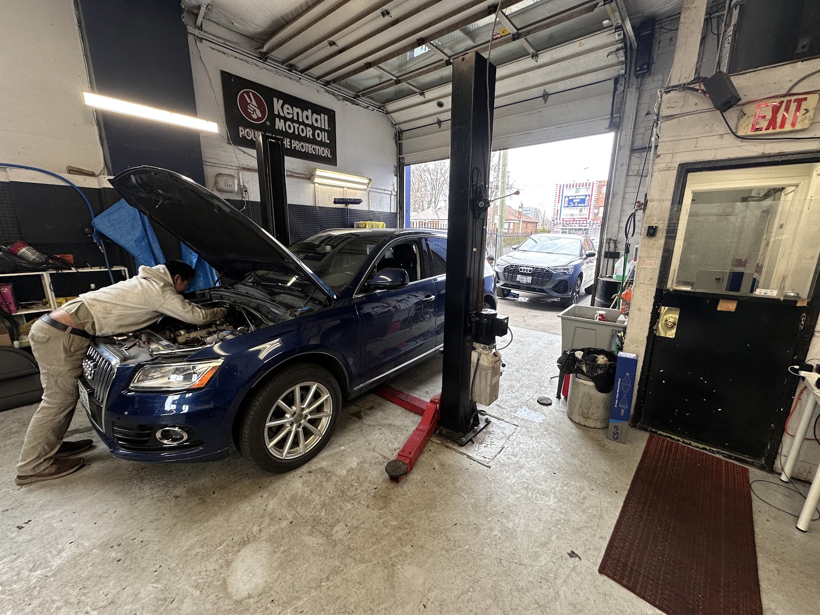 Mechanic working under the hood at ZS Automotive